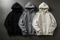 Three premium oversized hoodies in Jet Black, Stone Grey, and Off-White Cream